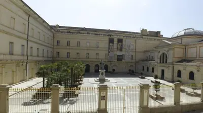 a large building with a fountain in a courtyard at Studio terrasse rue piétonne Ajaccio in Ajaccio