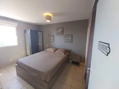 a bedroom with a large bed in a room at Zen home in Ajaccio