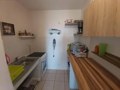a small kitchen with a sink and a stove at Zen home in Ajaccio