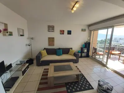 a living room with a couch and a coffee table at Zen home in Ajaccio