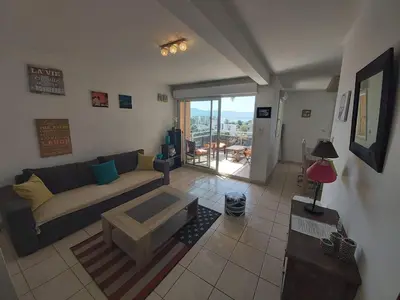 a living room with a couch and a table at Zen home in Ajaccio