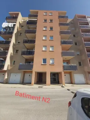 a tall apartment building with a car parked in front of it at Zen home in Ajaccio