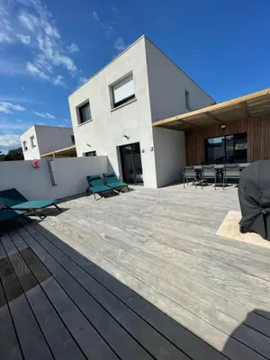 a patio with chairs and tables on a building at MAISON NEUVE PORTO VECCHIO in Porto-Vecchio