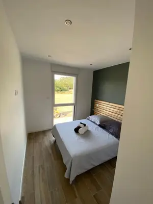 a bedroom with a bed and a window at MAISON NEUVE PORTO VECCHIO in Porto-Vecchio