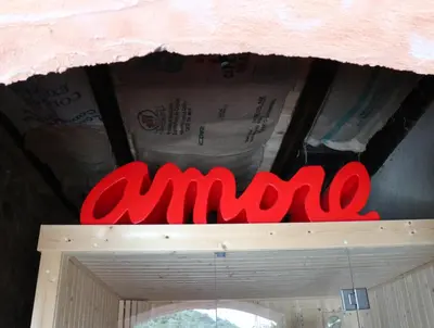 a red amazon sign on top of a door at 1722 Chambres de Charme in Ville-di-Paraso