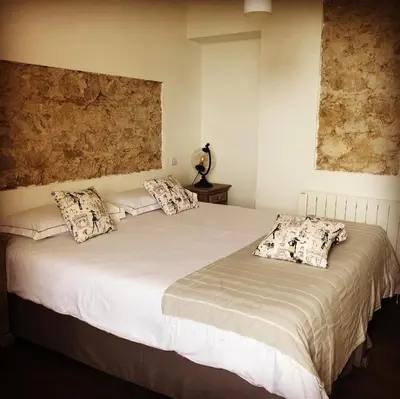 a bedroom with a large white bed with pillows at 1722 Chambres de Charme in Ville-di-Paraso