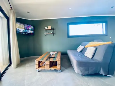 a living room with a blue couch and a coffee table at T2 Loft entre mer et montagne in Calenzana