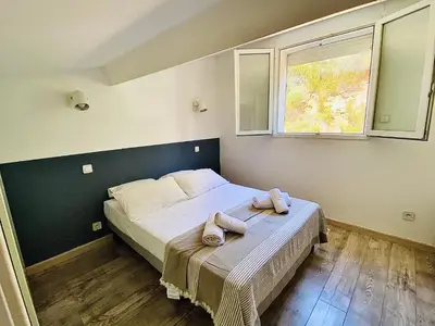 a bedroom with a bed with two towels on it at Propriété Malva appartement bergamotta in Alata