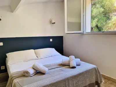 a bedroom with a bed with towels on it at Propriété Malva appartement bergamotta in Alata