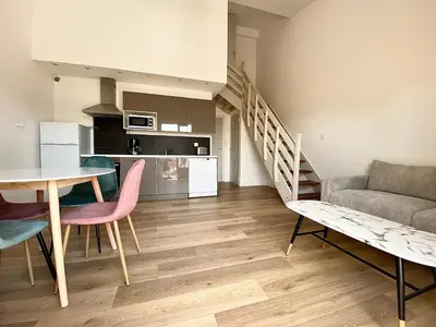 a living room with a table and a couch at Propriété Malva appartement bergamotta in Alata