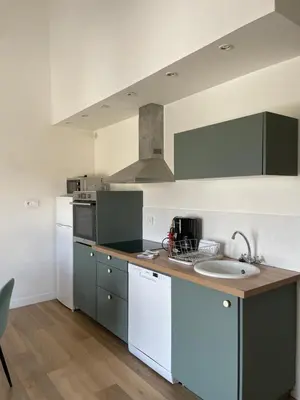 a kitchen with a sink and a counter top at Propriété Malva appartement bergamotta in Alata