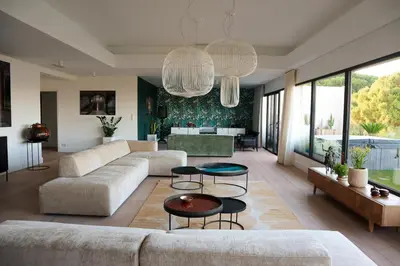 a living room with a couch and a table at CALADEA Locations de Vacances 5 étoiles, piscine chauffée in Porto-Vecchio