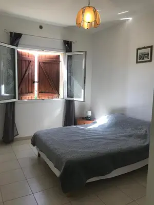 a bedroom with a large bed and a window at Gîtes à COZZANO in Cozzano