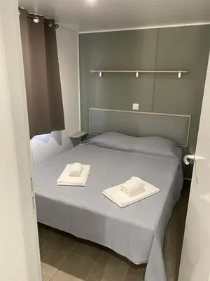 a bedroom with a bed with two towels on it at Palombaggia location i pini Porto Vecchio in Porto-Vecchio