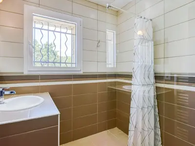 a bathroom with a sink and a shower at Holiday Home Villa Belios by Interhome in Porto-Vecchio