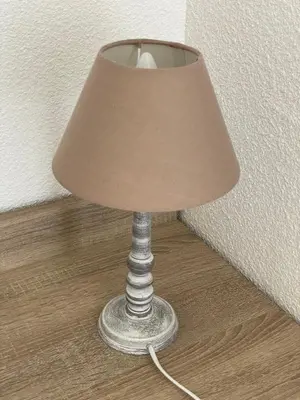 a lamp with a beige lamp shade on a wooden floor at Mini villa K2 in Bonifacio