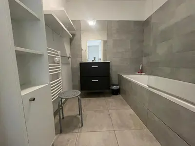 a bathroom with a sink and a tub and a stool at Mini villa K2 in Bonifacio