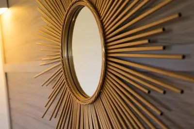 a mirror hanging on a wall with rays at Campo Vecchio Sole et Piscine in Ghisonaccia