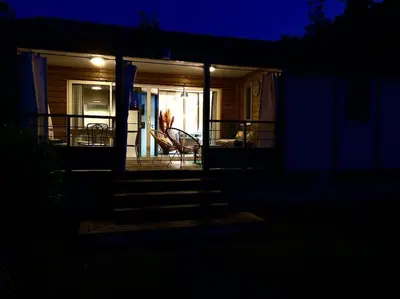 a night view of a house with a porch and stairs at Campo Vecchio Sole et Piscine in Ghisonaccia