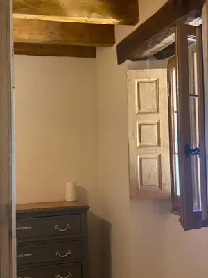 a bedroom with a dresser and a window at La bergerie du Chêne in Omessa