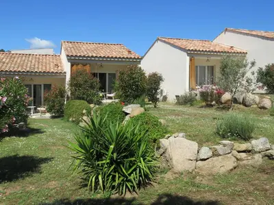 a house with a yard with rocks and trees at les terrasses d'arutoli in Porto-Vecchio