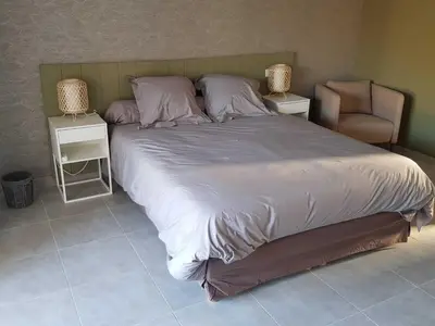 a bedroom with a sliding glass door leading to a patio at les terrasses d'arutoli in Porto-Vecchio