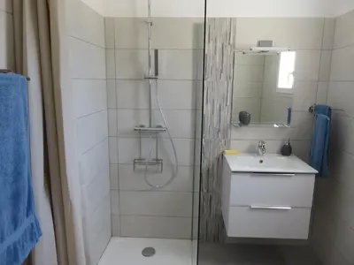 a bathroom with a sink and a mirror at les terrasses d'arutoli in Porto-Vecchio