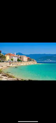 a view of a beach with people in the water at Ajaccio appartement vielle ville - 4 personnes in Ajaccio