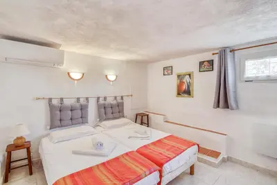 a bedroom with a white bed and a window at EL ORO - Terrasse Vue Mer et piscine - Porto Vecchio in Porto-Vecchio