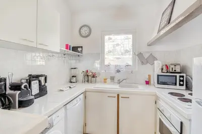a white kitchen with a sink and a microwave at EL ORO - Terrasse Vue Mer et piscine - Porto Vecchio in Porto-Vecchio
