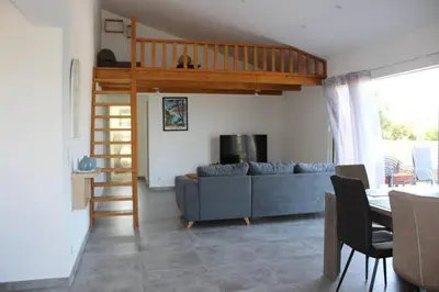 a living room with a couch and a loft at CASE DI A CAPPANA-Villa VINCENT in Bonifacio