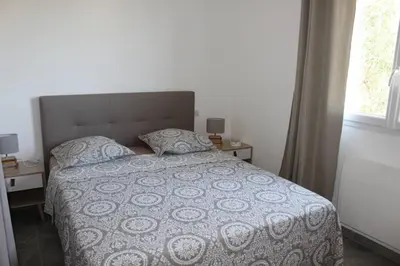 a bedroom with a bed and a window at CASE DI A CAPPANA-Villa VINCENT in Bonifacio