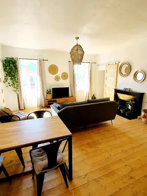 a living room with a couch and a table at Appartement au cœur de Sartene in Sartène