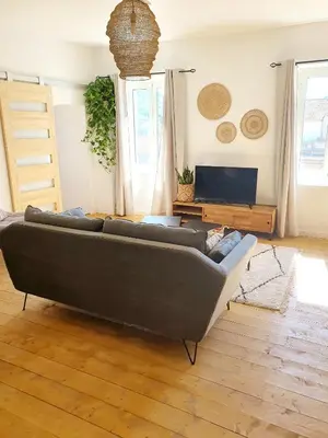 a living room with a couch and a tv at Appartement au cœur de Sartene in Sartène