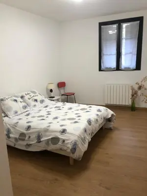 a bedroom with a bed with a comforter on it at Maison au centre d'un village typique in Omessa