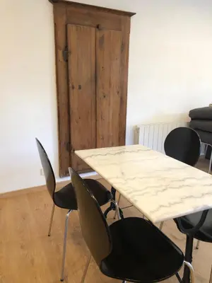 a table and chairs in a room with a table at Maison au centre d'un village typique in Omessa