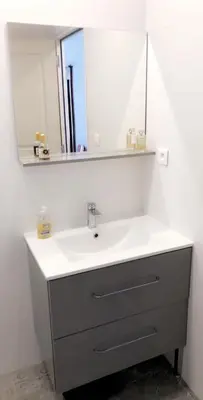 a bathroom with a white sink and a mirror at Maison au centre d'un village typique in Omessa
