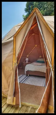 a canvas tent with a bed in it at Sottu E Stelle in Albitreccia