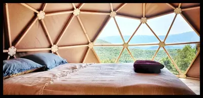a bedroom with a large window in a yurt at Sottu E Stelle in Albitreccia