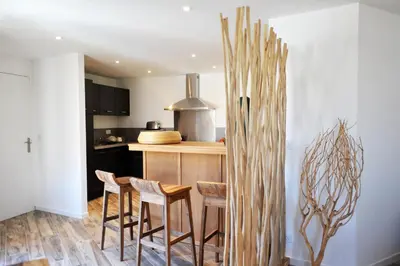 a kitchen with a counter and stools in a kitchen at clemente en aparté nord in Lecci