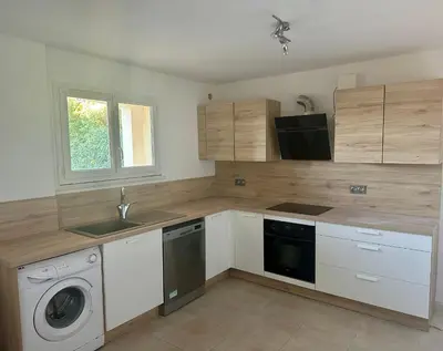 a kitchen with a washing machine and a sink at RINESA II in Porticcio