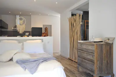 a bedroom with a bed and a wooden dresser at Clemente en aparté sud in Lecci
