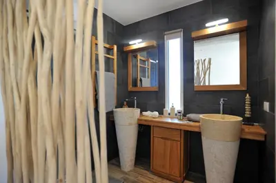 a bathroom with two sinks and a mirror at Clemente en aparté sud in Lecci
