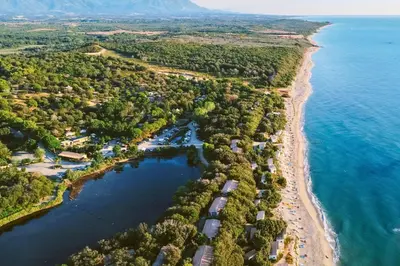 an aerial view of a beach and the ocean at Camping Naturiste Riva Bella 4* in Linguizzetta