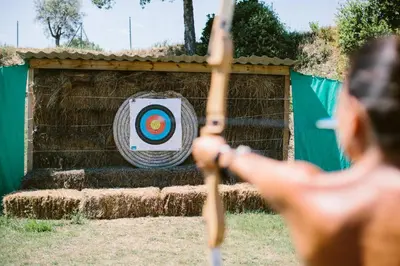 a man swinging a bat at a target at Camping Naturiste Riva Bella 4* in Linguizzetta
