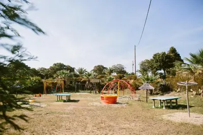 a park with a playground with a roller coaster at Camping Naturiste Riva Bella 4* in Linguizzetta