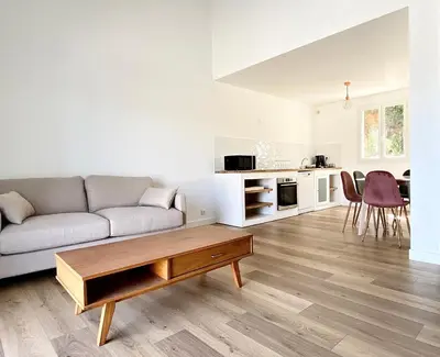 a living room with a couch and a table at Propriété Malva appartement agava in Alata