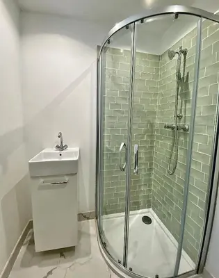a bathroom with a shower and a sink at Propriété Malva appartement agava in Alata