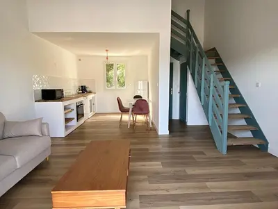 a living room with a couch and a table at Propriété Malva appartement agava in Alata