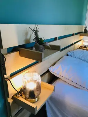 a bedroom with a bed with a lamp on it at Résidence Standing Domaine d Arca in Porto-Vecchio